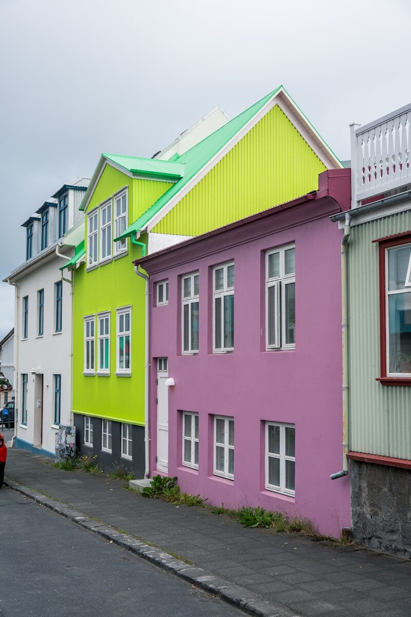Colorful houses line a street under a cloudy sky.